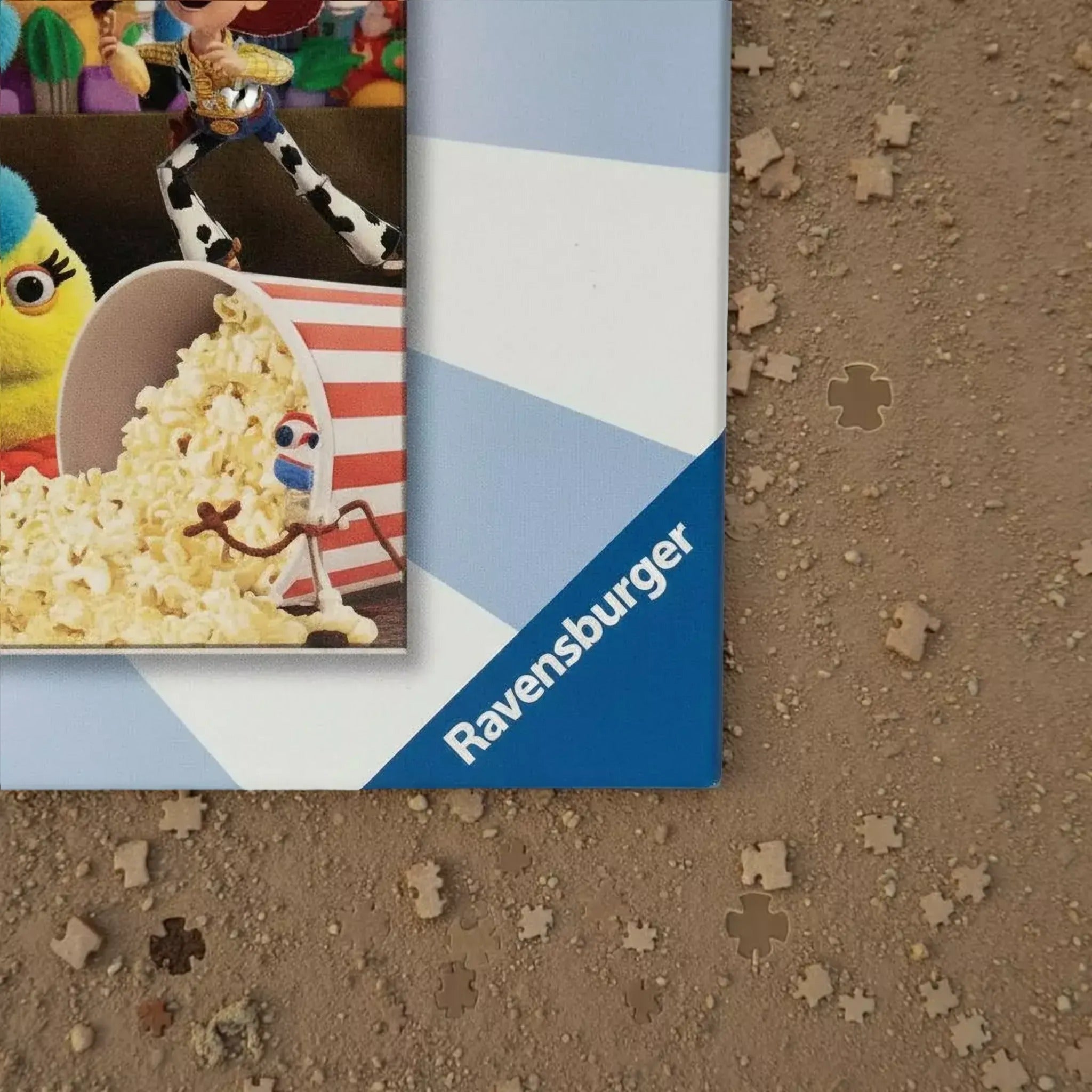 a close-up of a framed picture with a character from the Toy Story movie, specifically Woody, sitting in a bucket of popcorn.